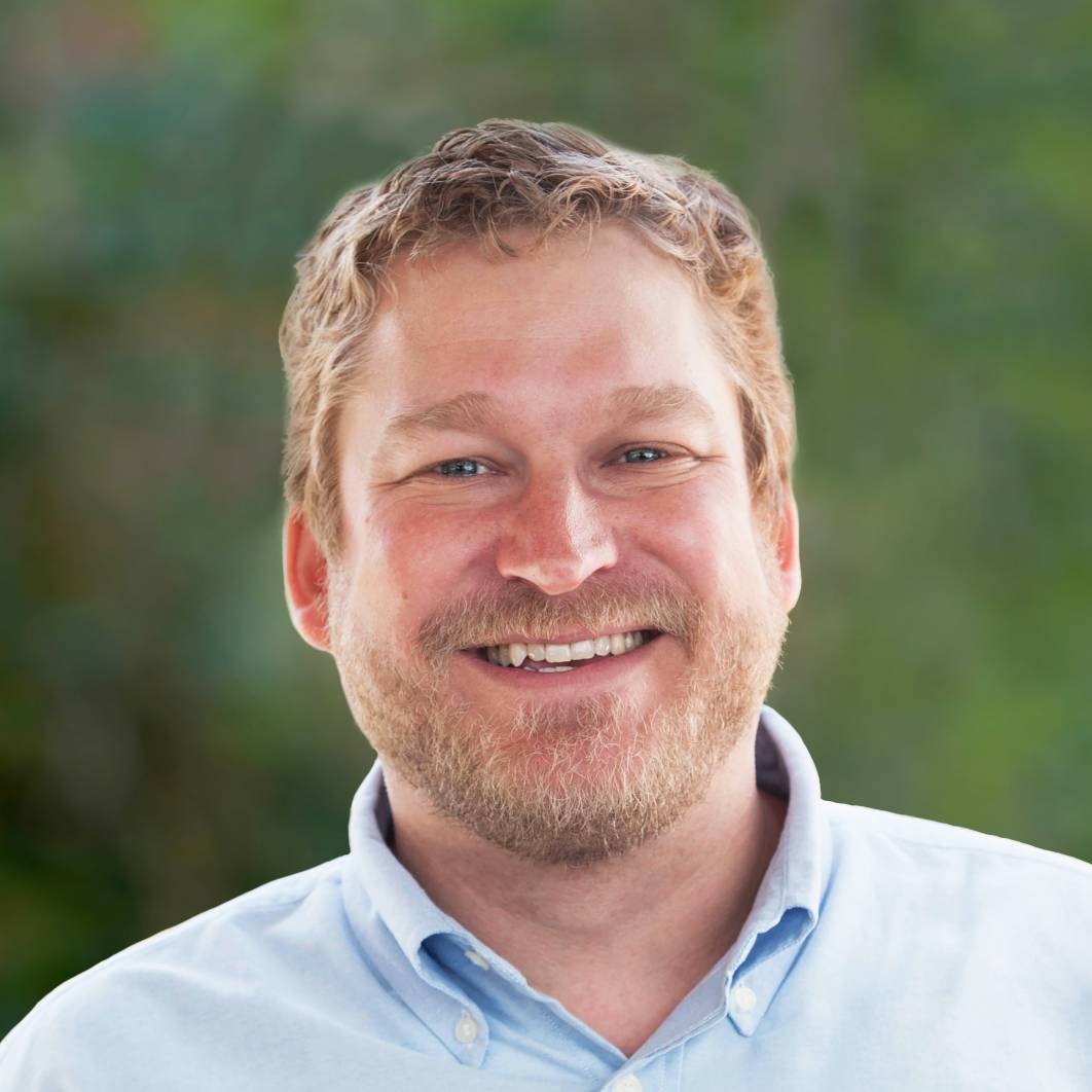 smiling-farallon-employee-with-curly-strawberry-blond-hair-and-goatee