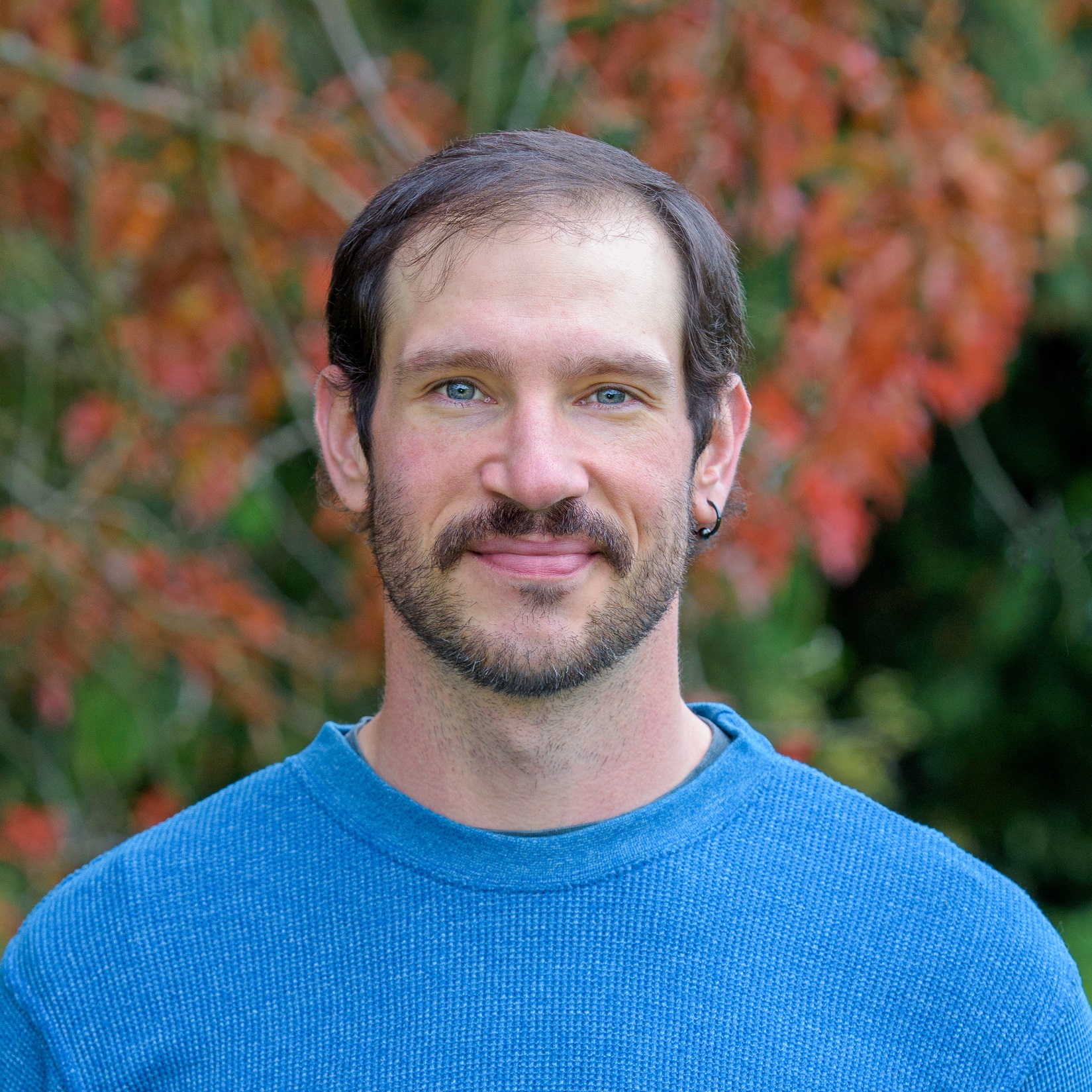 smiling-farallon-employee-with-short-dark-hair-and-very-blue-eyes