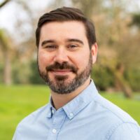 smiling-farallon-employee-with-dark-hair-and-beard