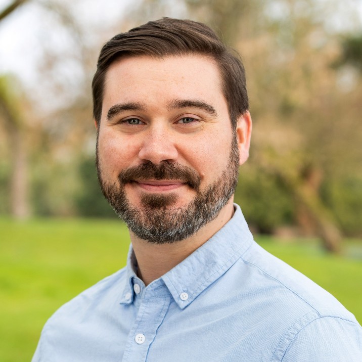 smiling-farallon-employee-with-dark-hair-and-beard
