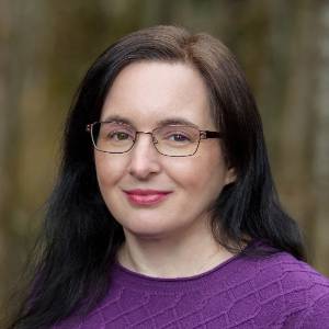 smiling-farallon-employee-with-long-dark-hair-and-purple-sweater