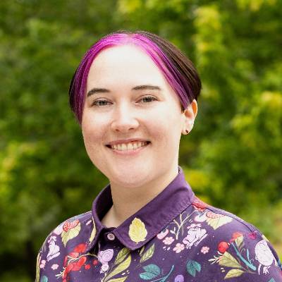 smiling-farallon-employee-with-short-purple-and-black-hair
