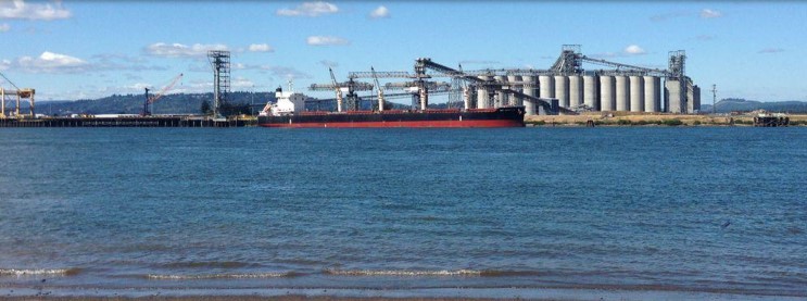 cargo ship next to a dock