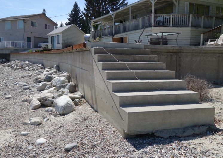 concrete stairs next to rocks
